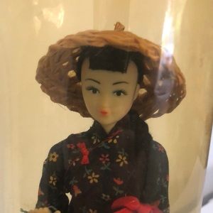 China doll in plastic storage container